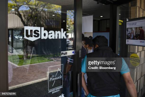 Customers enter a US Bancorp branch in Alameda, California, U.S., on Monday, April 9, 2018. US Bancorp is scheduled to release earning figures on...