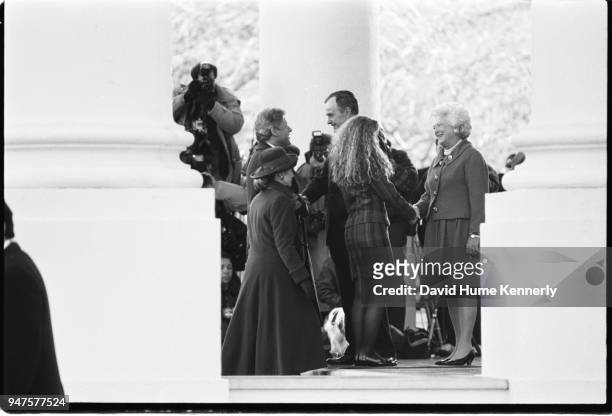 President George HW Bush and First Lady Barbara Bush greet the Clintons as they arrive at the White House before the first inauguration of Bill...
