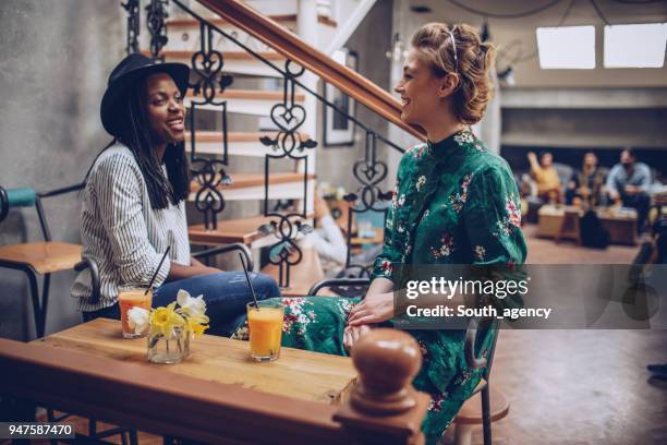 lesbian couple in coffee shop - lesbian date stock pictures, royalty-free photos & images