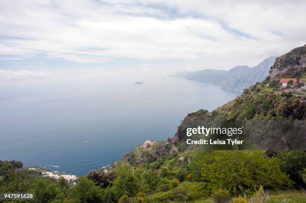 Houses cling to the cliffs from the Path of the Gods, a hiking trail from Agerola to Positano on the Amalfi coast that is said to run so close to...