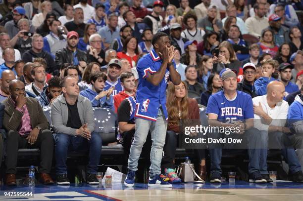 Kevin Hart cheers from the sideline while he attends a game between Miami Heat and Philadelphia 76ers in Game Two of Round One of the 2018 NBA...