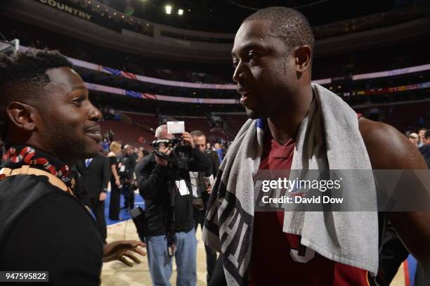 Dwyane Wade of the Miami Heat speaks to Antonio Brown after the game against the Philadelphia 76ers in Game Two of Round One of the 2018 NBA Playoffs...