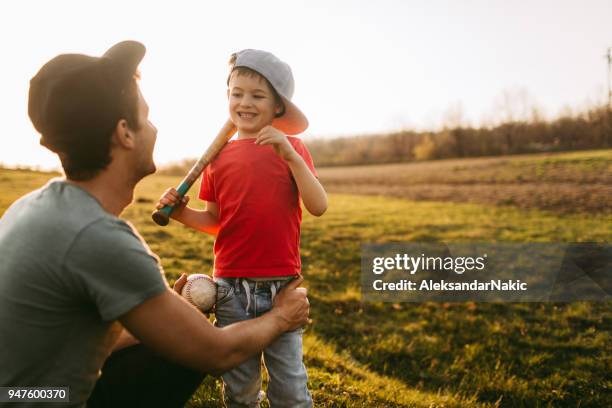 father and son getting ready for a game of baseball - baseball kid stock pictures, royalty-free photos & images