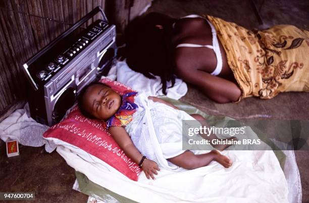 Femme dormant dans la rue avec son bébé à Madagascar.