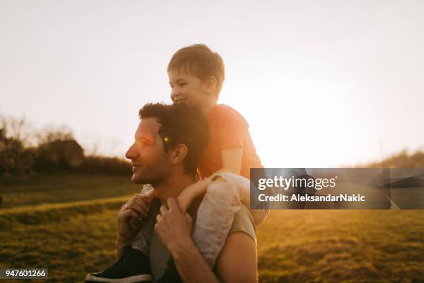 piggyback ride in nature - carrying on shoulders stock pictures, royalty-free photos & images
