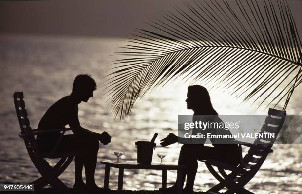 Couple buvant du champagne sur une plage des Maldives.