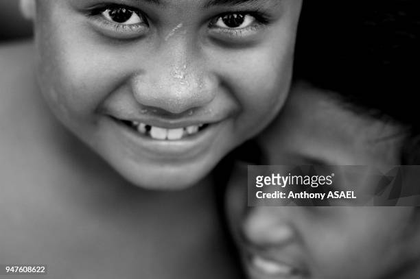 Samoa, Apia Upolu Island, close up portrait of 2 boys smiling.