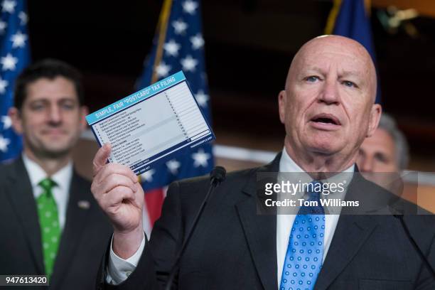 Ways and Means chairman Rep. Kevin Brady, R-Texas, holds a sample of a postcard-style tax filing during a news conference in the House studio after a...