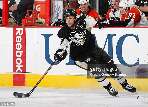 Craig Adams of the Pittsburgh Penguins makes a pass against the Philadelphia Flyers on December 15, 2009 at Mellon Arena in Pittsburgh, Pennsylvania.