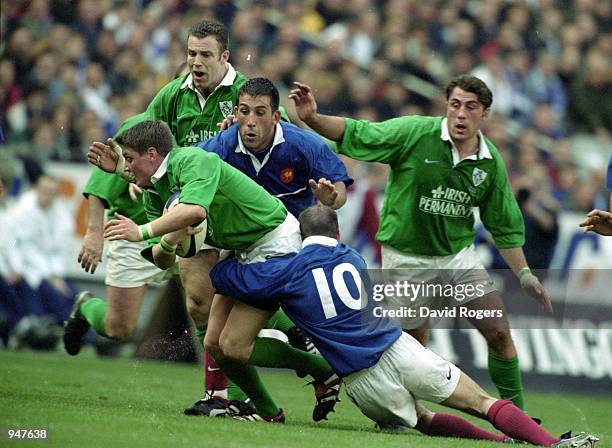 Ronan O''Gara of Ireland is tackled by Arnaud Costes and Gerald Merceron of France during the Six Nations 2000 Championship match played at the Stade...