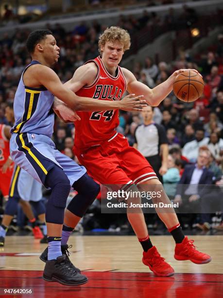 Lauri Markkanen of the Chicago Bulls drives against Ivan Rabb of the Memphis Grizzlies at the United Center on March 7, 2018 in Chicago, Illinois....