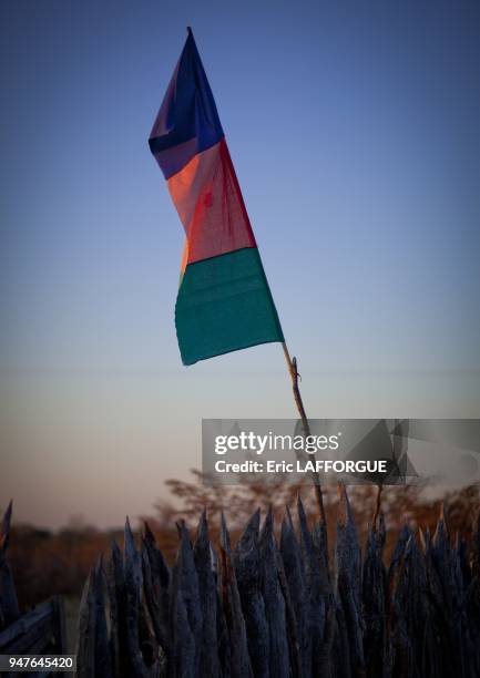 Flag of a political party Ovambo people are farmers living in Angola. They build high wooden faces around their villages to protect from elephant...