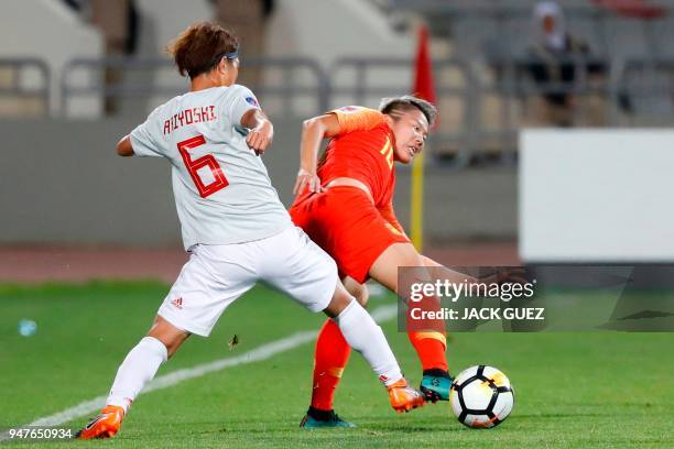 Japan's midfielder Saori Ariyoshi vies for the ball with China's forward Ying Li during the AFC Women's Asian Cup Semi Final match between Japan and...