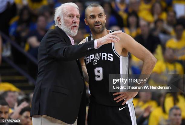 Head coach Gregg Popovich of the San Antonio Spurs talks with his player Tony Parker against the Golden State Warriors in the second quarter during...