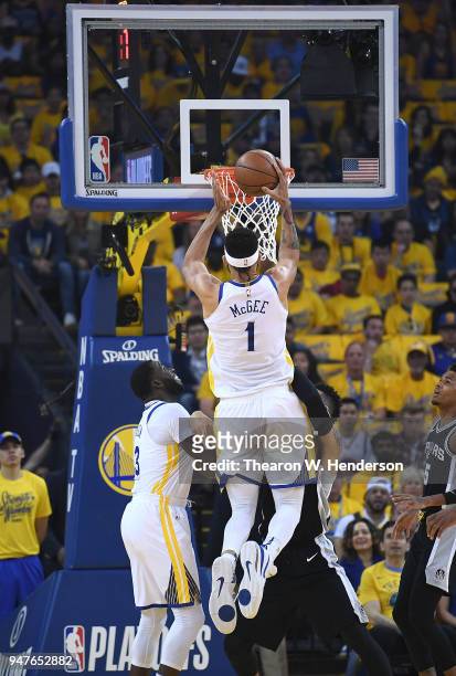 JaVale McGee of the Golden State Warriors goes in for a layup over Danny Green of the San Antonio Spurs in the first quarter during Game One of the...