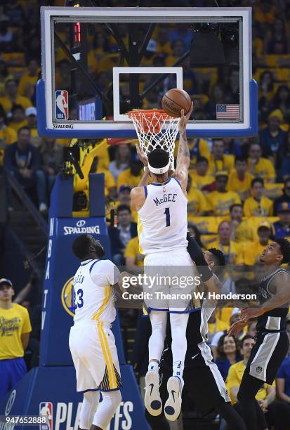 JaVale McGee of the Golden State Warriors goes in for a layup over Danny Green of the San Antonio Spurs in the first quarter during Game One of the...