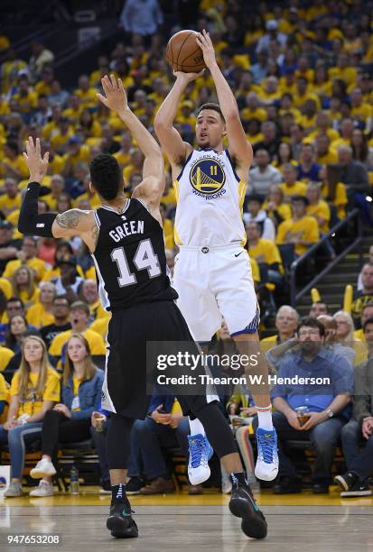 Klay Thompson of the Golden State Warriors shoots over Danny Green of the San Antonio Spurs in the third quarter during Game One of the first round...