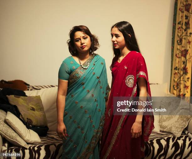 exasperated mother with teenage daughter, wearing saris - palmerston stock pictures, royalty-free photos & images