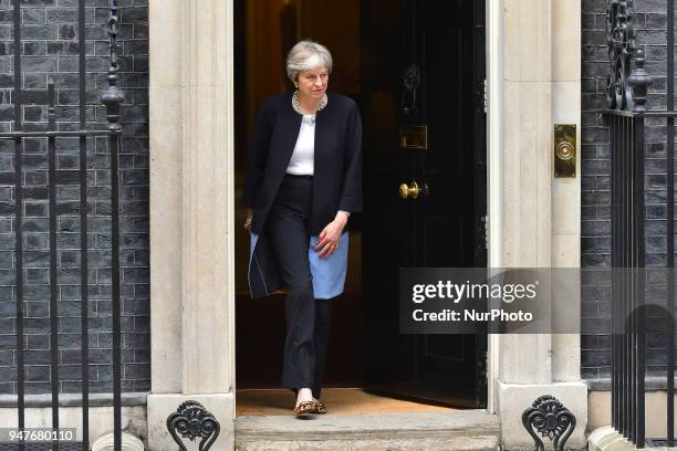 Britain's Prime Minister Theresa May steps down from number 10 to meet South Africa's President Cyril Ramaphosa in central London, prior to bilateral...