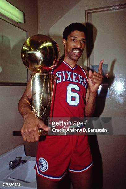 Julius Erving of the Philadelphia 76ers holds the Larry O'Brien Trophy after Game Four of the 1983 NBA Finals game against the Los Angeles Lakers on...