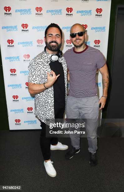 Enrique Santos and Rene Perez Joglar "Residente" pose together during his visit at The "Enrique Santos Show" At The I Heart Latino Studio on April...