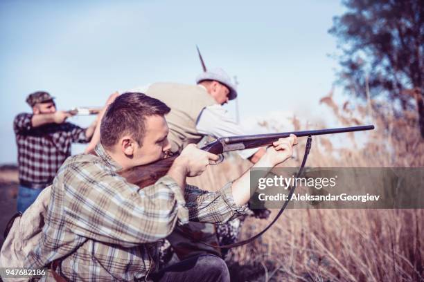 group of hunters with their dogs in action - hobby bird of prey stock pictures, royalty-free photos & images