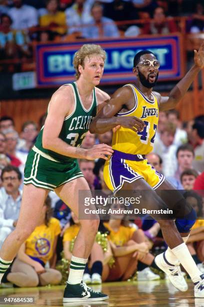 Larry Bird of the Boston Celtics defends James Worthy of the Los Angeles Lakers during the game on February 17, 1985 at The Forum in Inglewood,...