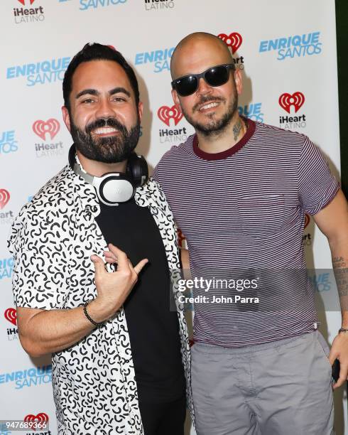 Enrique Santos and Rene Perez Joglar "Residente" pose together during his visit at The "Enrique Santos Show" At The I Heart Latino Studio on April...