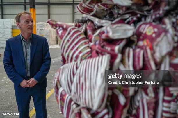 Phil Wild, CEO of James Cropper PLC, poses next to thousands of take-away coffee cups waiting to be recycled at James Cropper recycling plant on...