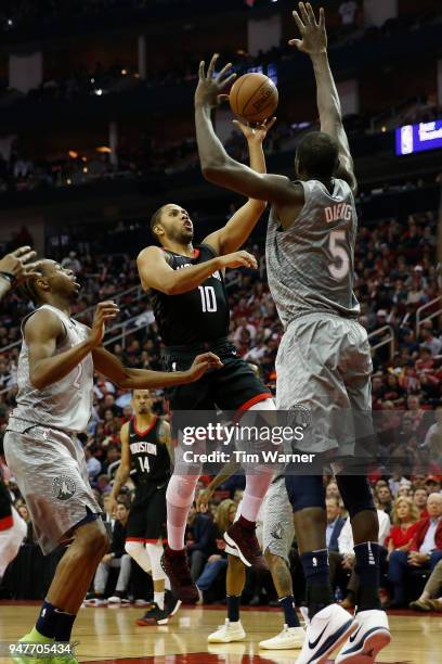 Eric Gordon of the Houston Rockets goes up for a shot defended by Gorgui Dieng of the Minnesota Timberwolves and Andrew Wiggins in the first half...