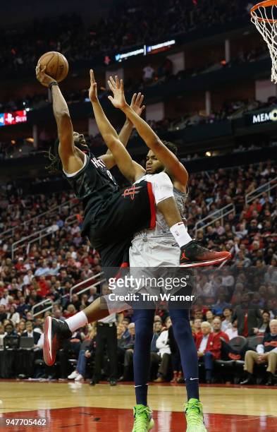 Nene Hilario of the Houston Rockets drives to the basket defended by Karl-Anthony Towns of the Minnesota Timberwolves in the first half during Game...
