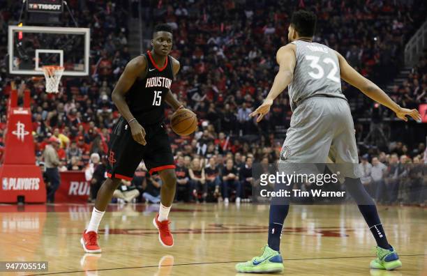 Clint Capela of the Houston Rockets dribbles the ball defended by Karl-Anthony Towns of the Minnesota Timberwolves in the first half during Game One...