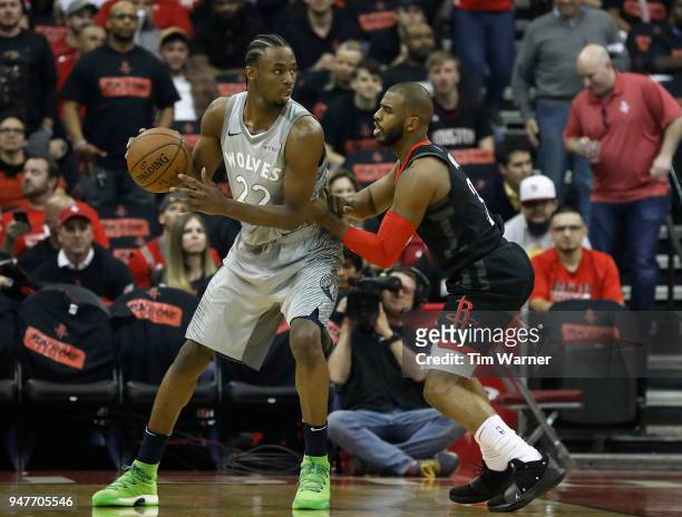 Andrew Wiggins of the Minnesota Timberwolves controls the ball defended by Chris Paul of the Houston Rockets in the first half during Game One of the...