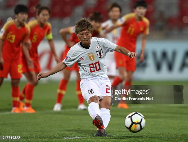 Yokoyama Kumi of Japan scores a penalty during the AFC Women's Asian Cup semi final match between China and Japan at the King Abdullah II Stadium on...