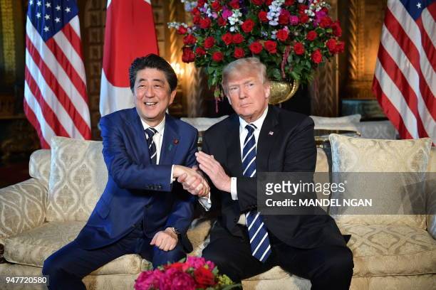 President Donald Trump greets Japanese Prime Minister Shinzo Abe as he arrives for talks at Trump's Mar-a-Lago resort in Palm Beach, Florida, on...