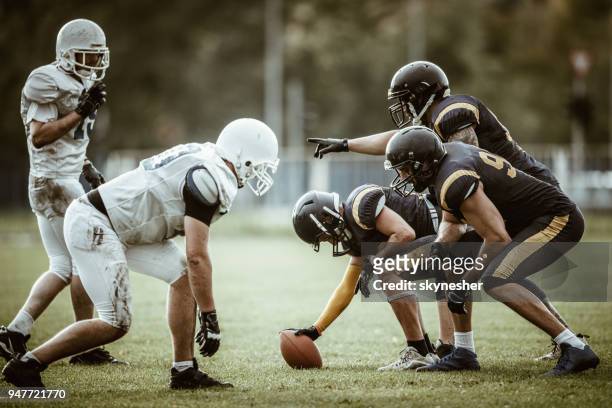 american football players on a beginning of the match. - american football lineman stock pictures, royalty-free photos & images