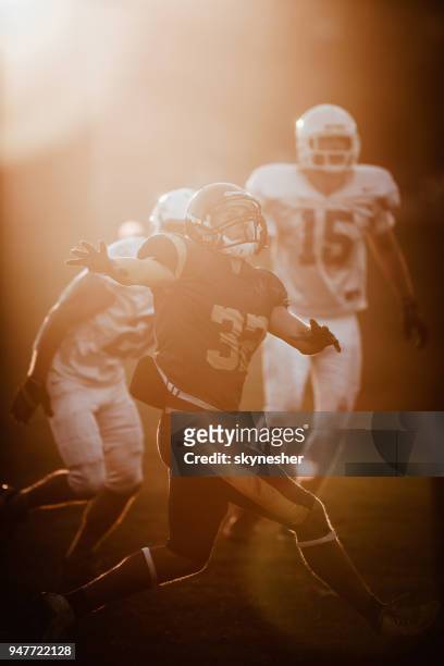 american football match at sunset! - quarterback stock pictures, royalty-free photos & images
