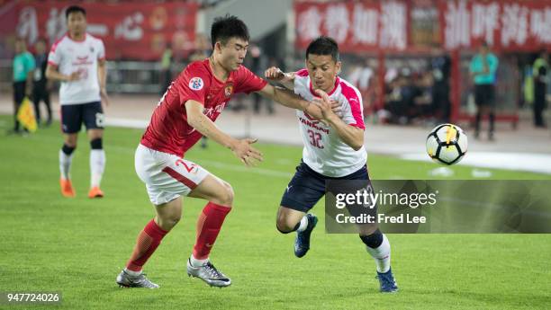 Deng hanwen of Guangzhou Evergrande Taobao and Atomu Tanaka of Cerezo Osaka in action during the 2018 AFC Champions League Group G match between...
