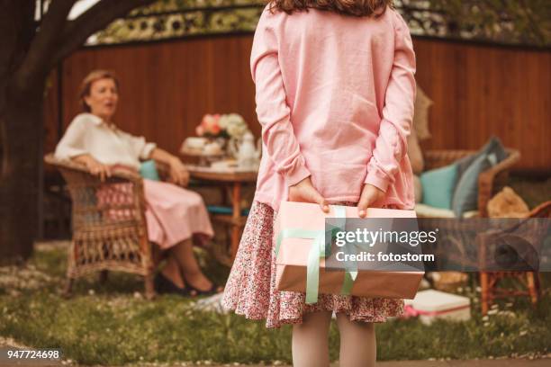 girl with a surprise gift - may month stock pictures, royalty-free photos & images