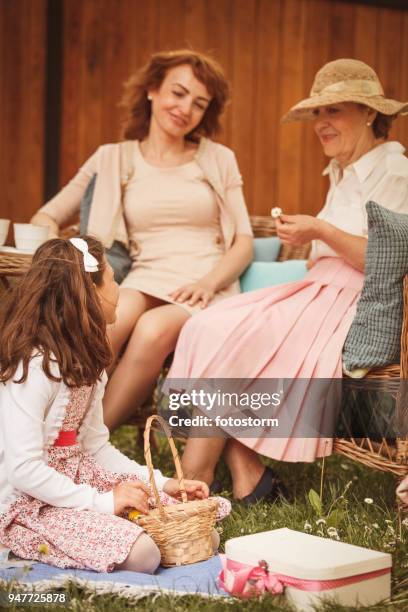 ladies relaxing in the garden - tea party hats for kids stock pictures, royalty-free photos & images