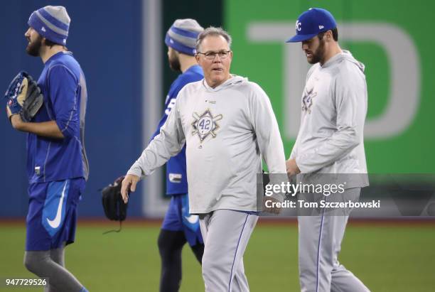 Manager Ned Yost of the Kansas City Royals walks on the field with his players as their MLB game against the Toronto Blue Jays was postponed due to...
