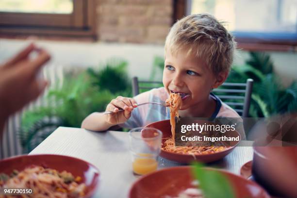 little boy eating spaghetti lunch - the joys of eating spaghetti stock pictures, royalty-free photos & images