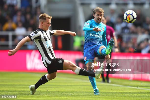 Matt Ritchie of Newcastle United in action with Nacho Monreal of Arsenal during the Premier League match between Newcastle United and Arsenal at St....