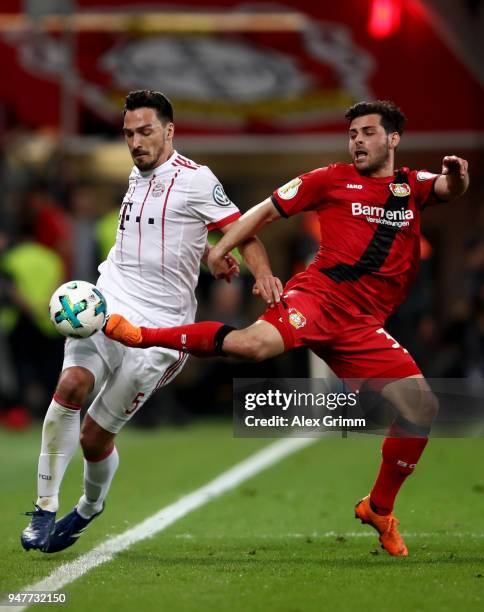 Kevin Volland of Leverkusen and Mats Hummels of Muenchen battle for the ball during the DFB Cup semi final match between Bayer 04 Leverkusen and...