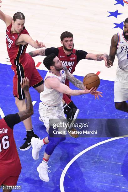 Redick of the Philadelphia 76ers lays up a shot against Tyler Johnson and Kelly Olynyk of the Miami Heat during game two of round one of the 2018 NBA...