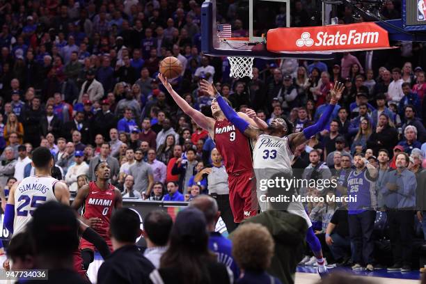 Kelly Olynyk of the Miami Heat reacts gets a rebound against Robert Covington of the Philadelphia 76ers late in the fourth quarter during game two of...