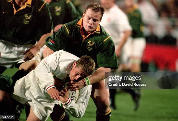Jonny Wilkinson of England is tackled by Robbie Kempson of South Africa during the Second Test match played at the Free State Stadium in...