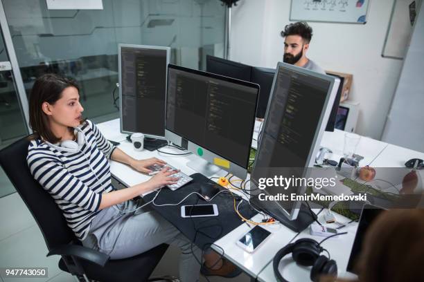 young female computer programmer working on computer - application developer stock pictures, royalty-free photos & images