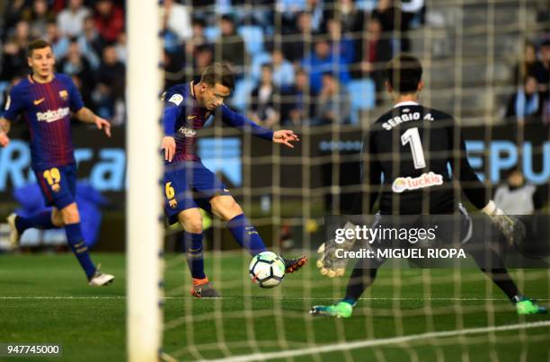 Barcelona's Spanish midfielder Denis Suarez shoots in front of Celta Vigo's Spanish goalkeeper Sergio Alvarez during the Spanish league football...