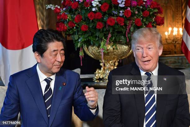 President Donald Trump and Japan's Prime Minister Shinzo Abe share a laugh as they speak to media during a bilateral meeting at Trump's Mar-a-Lago...